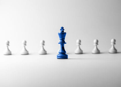 Chess piece standing out to signify leadership